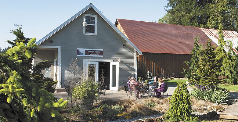 Guests relax on the Heisen House tasting room’s patio. The winery hosts many events throughout the year.##Photo by Del Munroe