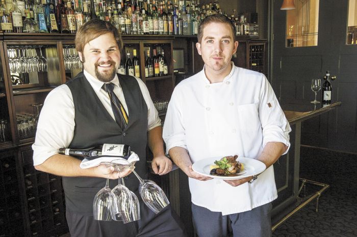 Executive Chef Billy Busher (right) and sommelier Drew Gibbs take care of their loyal customers at Alchemy inside The Winchester Inn. Photo by Andrea Johnson.