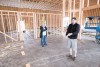 Caroline Biggio Hamina listens as Todd Hamina describes the layout of their new facility, which is currently under construction. Photo
by Marcus Larson.