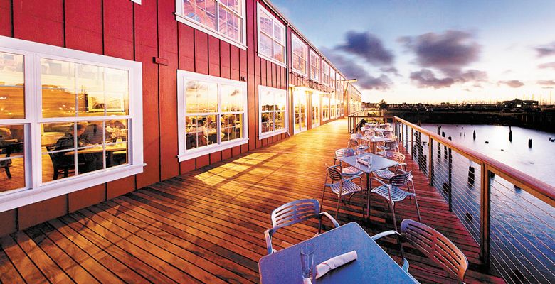 The boardwalk at Bridgewater Bistro glows from the lights inside. During the day, these seats fill with diners opting for fresh sea air. ##Photo provided.