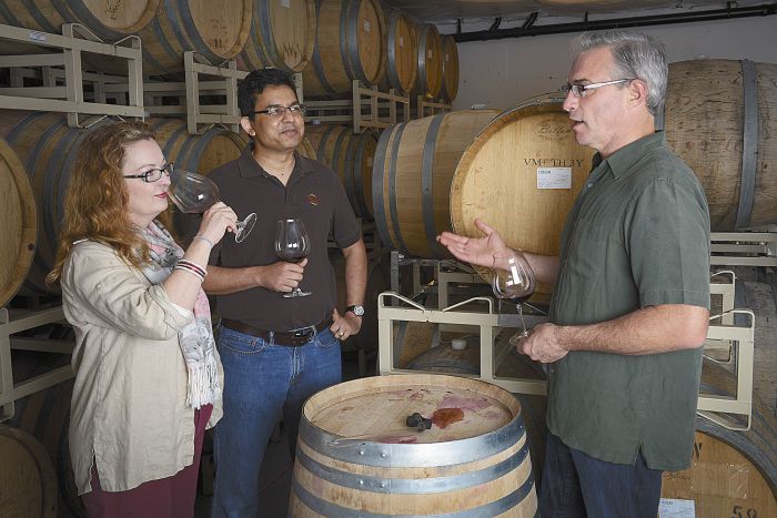 Tony Rynders discusses wine with Saffron Fields owners Sanjeev Lahoti and Angela Summers. Rynders is the red winemaker for the Yamhill-Carlton winery. Photo by Andrea Johnson