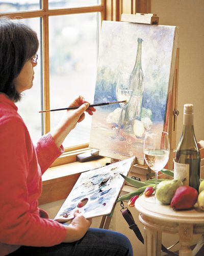 Amity artist Toni Tyree paints a still life of Chardonnay at Red Ridge Farms in Dayton.
Tyree specializes in watercolor and oil. Photo by Andrea Johnson