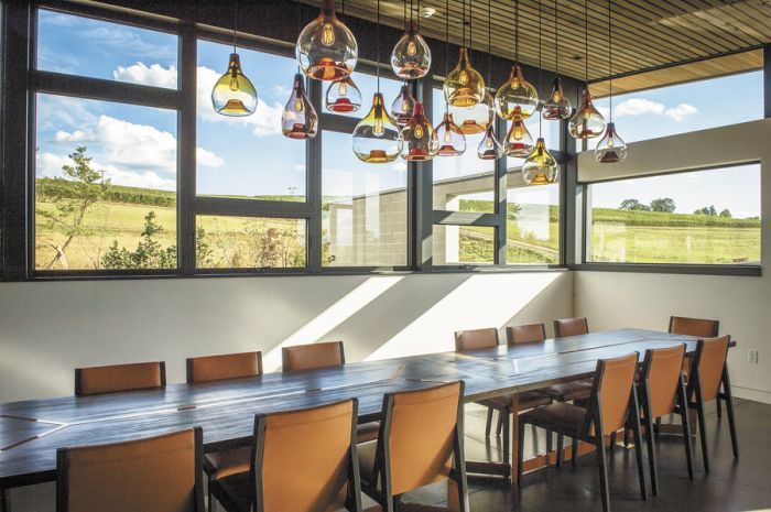 Light fixtures from Portland firm Esque Studio hang above a custom-made table inside Saffron Fields’ private dining/meeting room.