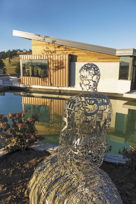 Jaume Plensa’s “Tale Teller II,” a life-sized sculpture crafted from stainless steel and stone sits at the edge of one of the ponds at Saffron Fields’ new tasting room.