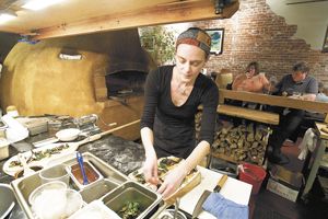 The Blue Goat in Amity recently opened its doors in the small wine country town of Amity.  Co-owner/chef Cassie VanDomelen assembles a pizza.