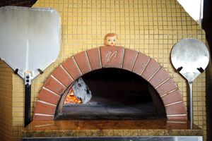  Dolly, the Patron Saint of Pizza  guards the wood-fire oven at the Firehouse in Northeast Portland.