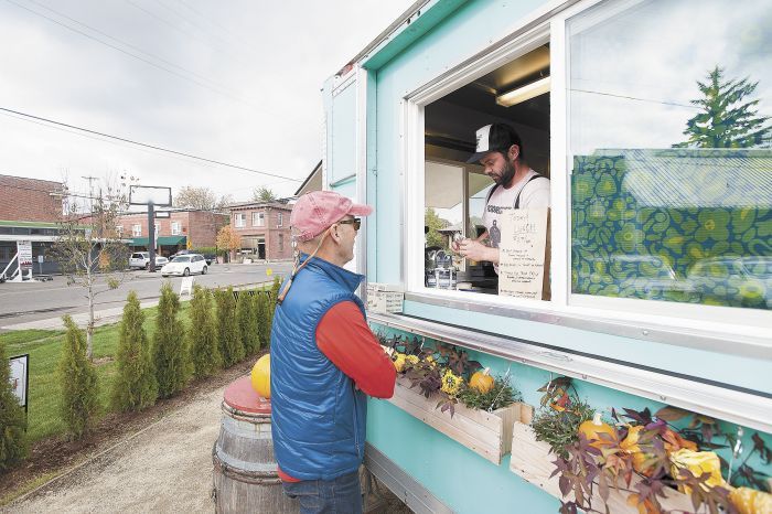 Chef Joseph Zumpano takes a customer’s order from inside his food truck known as Henry’s Diner.
