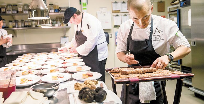Executive Chef Sunny Jin prepares one of many truffled courses during the dinner at The Allison. Both black and white truffles were featured. ##Photo by John Valls.