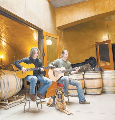 Jay Somers, winemaker/co-owner of J. Christopher Wines plays a tune with assistant winemaker Tim Malone at the Newberg winery. Cellar dog Nina listens to the music. Andrea Johnson/www.andreajohnsonphotography.com