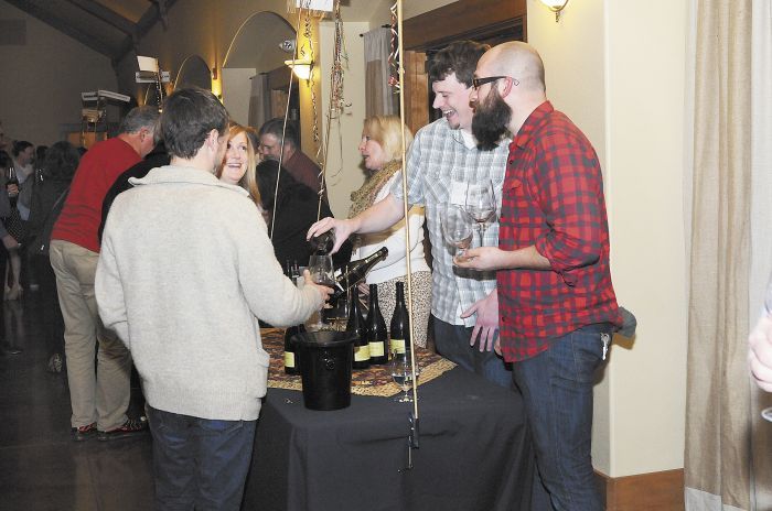 Winery representatives pour samples for guests at the 2014 event.