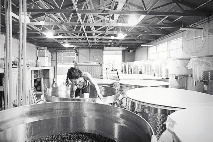 Sarah Cabot climbs into a tank while making Omero Pinot Noir.