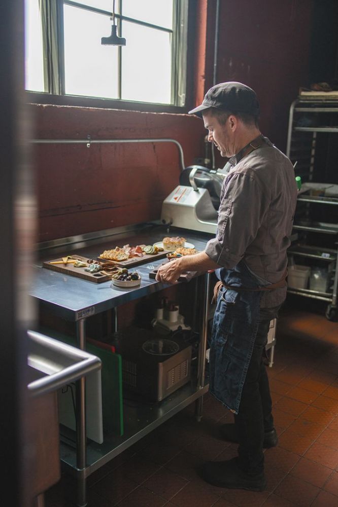 Chef Joey Gibson preparing cheese and charcuterie boards in Parallel’s kitchen. ## Photo by Josh Chang/Foundry 503 Chef Joey Gibson preparing cheese and charcuterie boards in Parallel’s kitchen. ## Photo by Josh Chang/Foundry 503