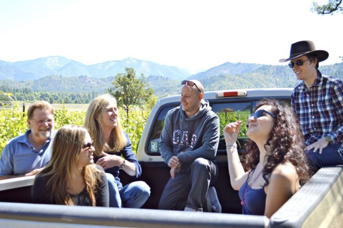 Joe and Suzi Ginet of Plaisance Ranch in Williams give French visitors, from left, Vaite Redolat, Cedric Buffet, Julie Laforet and Bruno Carle, their first trip in a pickup on the way to work in the vineyards. Photo courtesy of Mail Tribune/Janet Eastman.