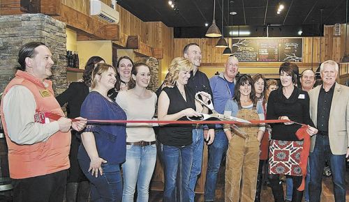 Jill House cuts the ribbon at the grand opening of Stave & Stone’s tasting room in Hood River. Family and friends joined in on the celebration. ##Photo provided