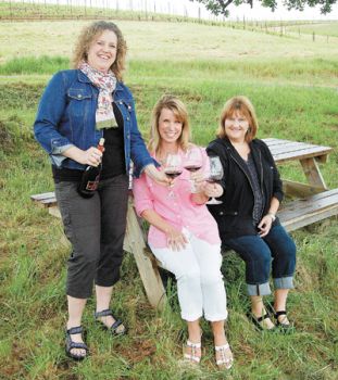 From left: Rebecca Moore, WWS national president; Amber Yates, head of Central Oregon WWS; and Larlene Dunsmuir, head of Portland WWS, toast WWS at Monks Gate
Vineyard, Moore&rsquo;s parents&rsquo; venture outside of Carlton in the Willamette Valley. Photo by Hilary Berg
