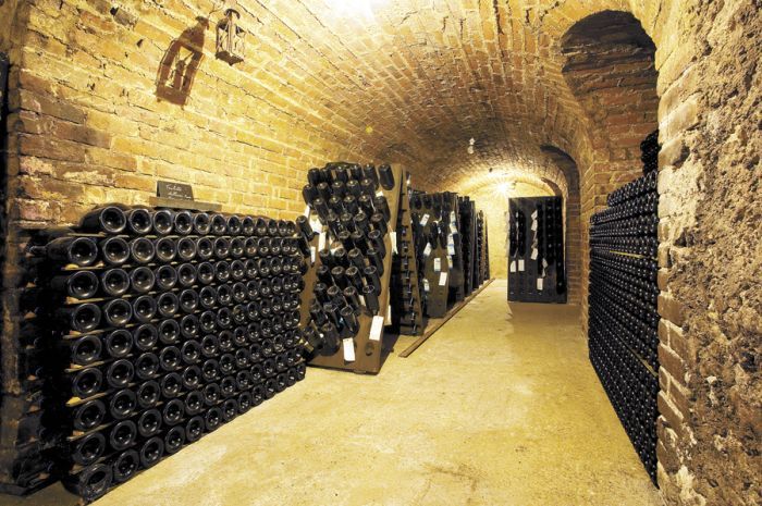 Sparkling fills an old wine cave at a Champagne house in Épernay, France. Stock photo.